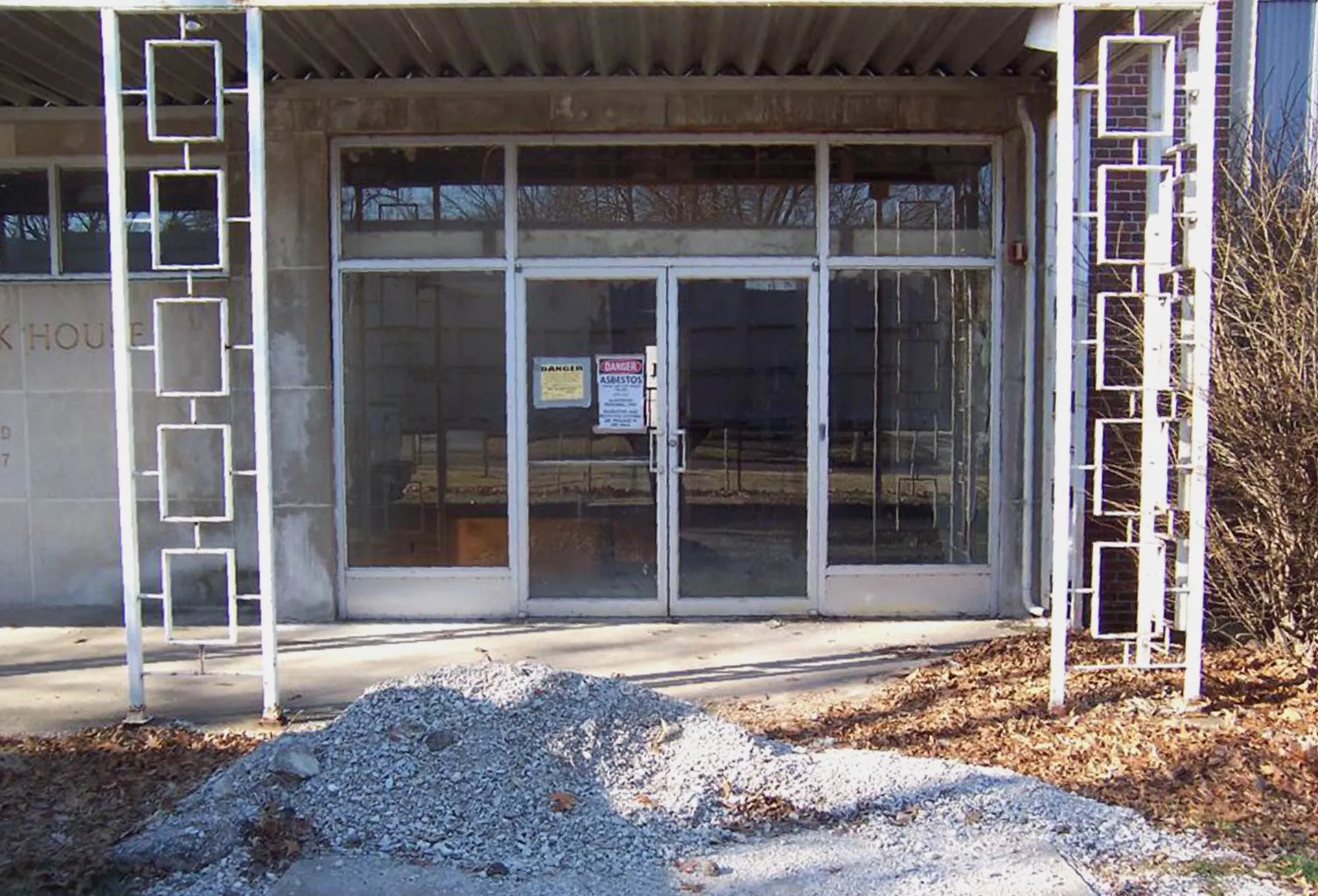 empty building with asbestos warning on door